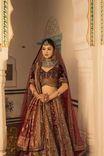 Multi Hued Flairy Bridal Lehenga Luxuriously Paired with Blouse, Dupatta and Bandhani Odhani.