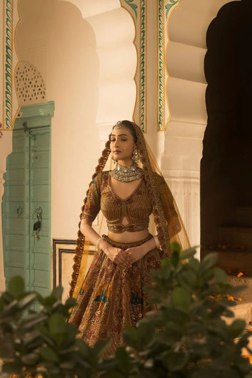 A Soft Mustard Hued Ball Bridal lehenga Paired with a Crop Top and Dupatta