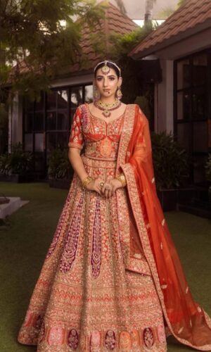 Rusty Orange Bridal Lehenga with Hand Stitched Workmanship  Paired with Crop Top and Dupatta