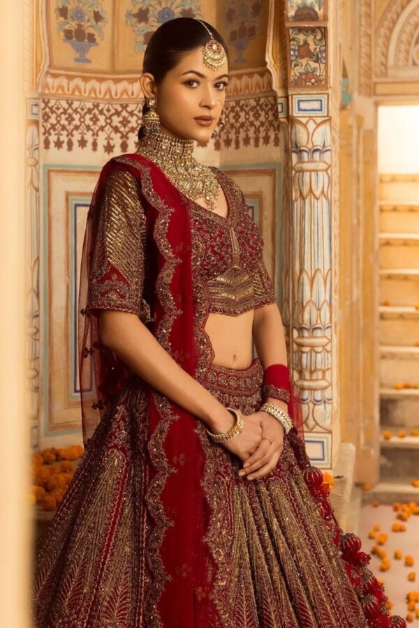 Cherry maroon bridal lehenga with handcrafted embroidery and scalloped dupatta