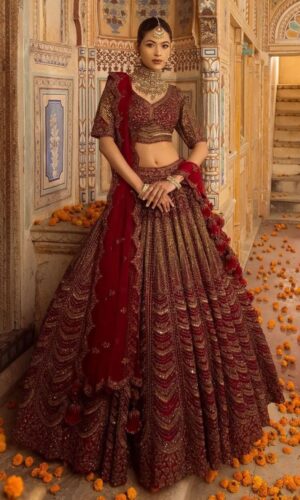 Cherry maroon bridal lehenga with handcrafted embroidery and scalloped dupatta