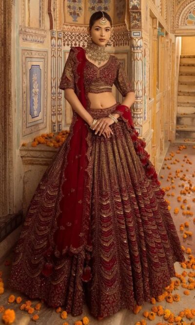 Cherry maroon bridal lehenga with handcrafted embroidery and scalloped dupatta