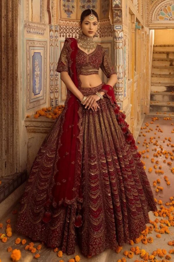 Cherry maroon bridal lehenga with handcrafted embroidery and scalloped dupatta