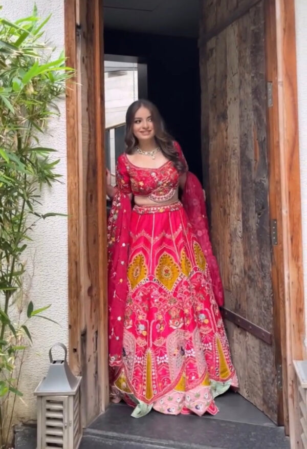 Rani pink hued appliqué lehenga with choli and dupatta