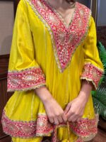 Mango Shaded Pakistani Anarkali Garara Suit with Appliqué Crafting and a Cute Potli.
