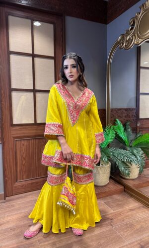 Mango Shaded Pakistani Anarkali Garara Suit with Appliqué Crafting and a Cute Potli.