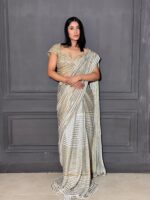 Cream tone drape saree with hand stiched highlights
