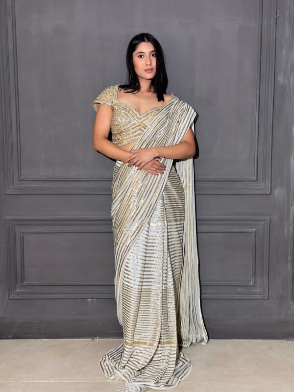 Cream tone drape saree with hand stiched highlights